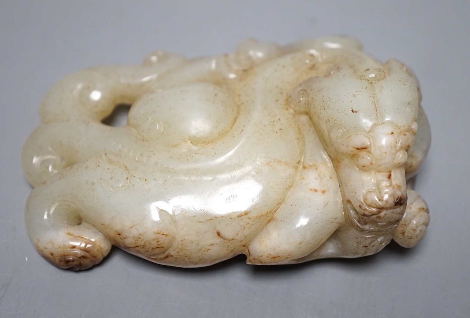 A Chinese pale celadon jade chilong carving, 10cm